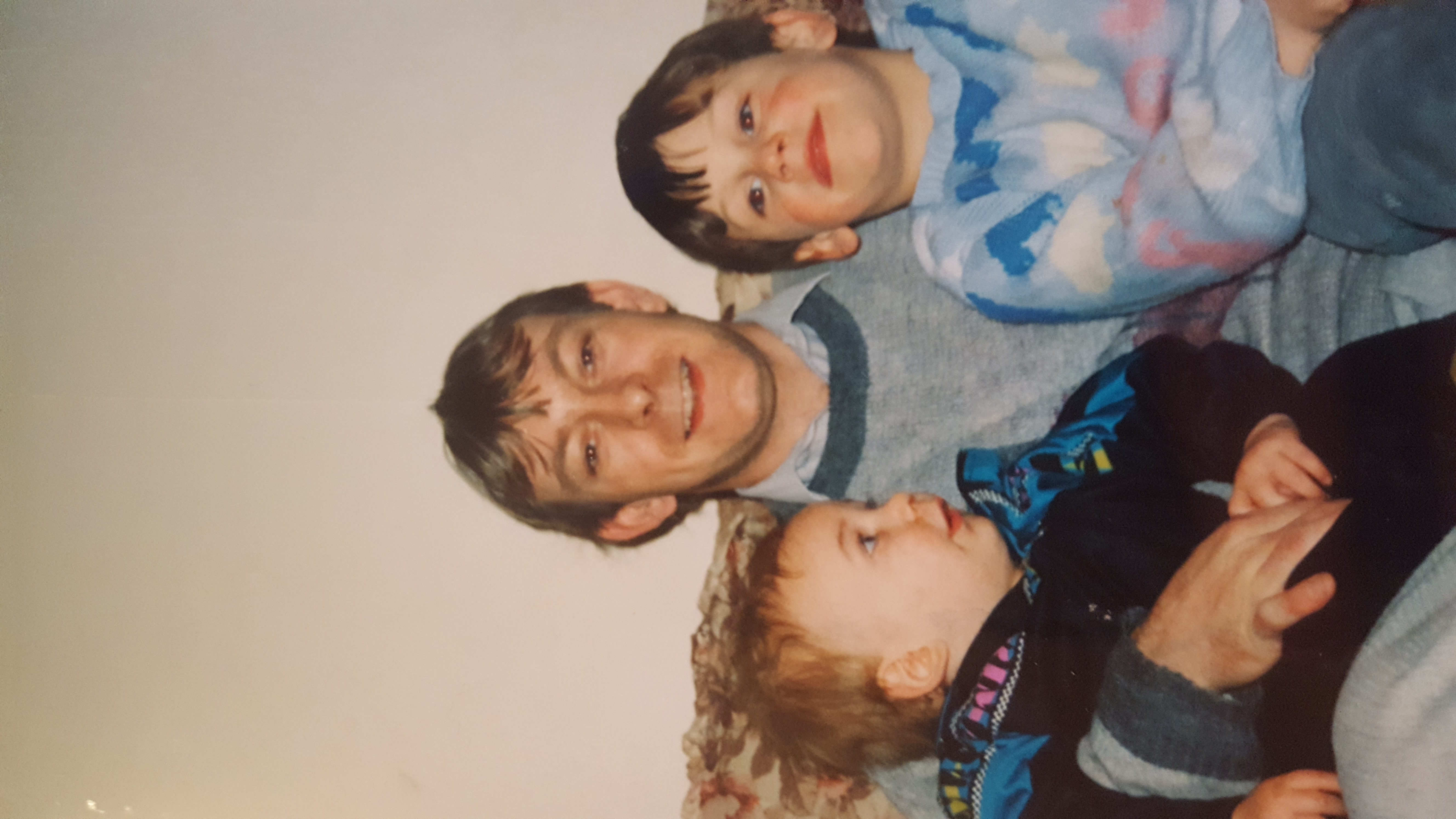 A family photo of me, my dad, and my brother.